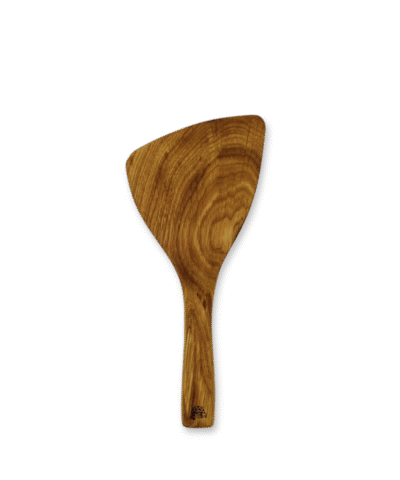 Hand-carved natural oak mini spatula with curved edge and smooth finish, lying on a neutral linen surface.