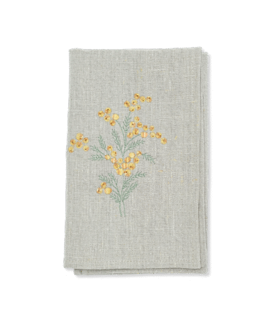 Folded linen kitchen towel with sea buckthorn embroidery
